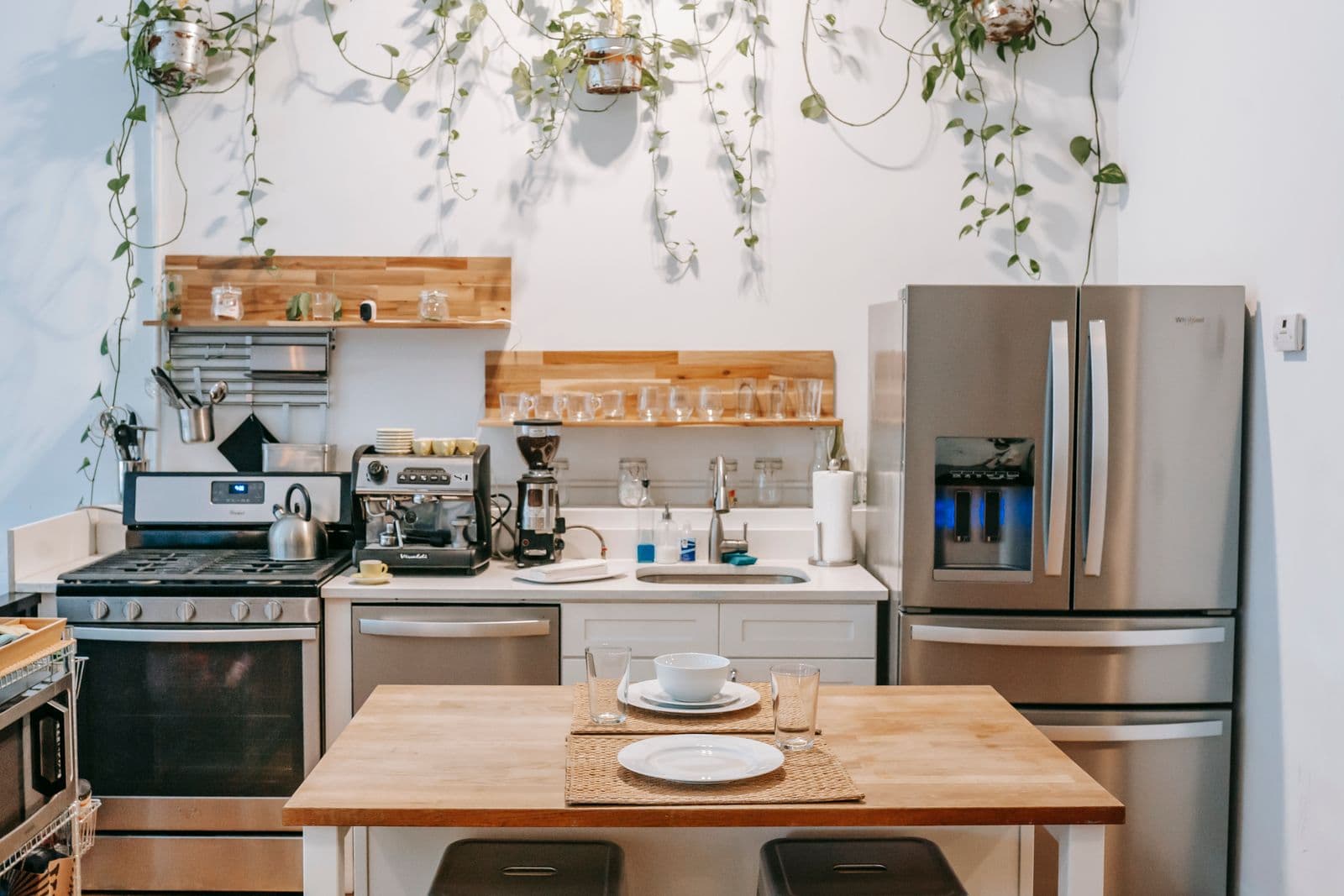 Compact remodeled kitchen using open oak shelving and a small island to maximize a tight footprint